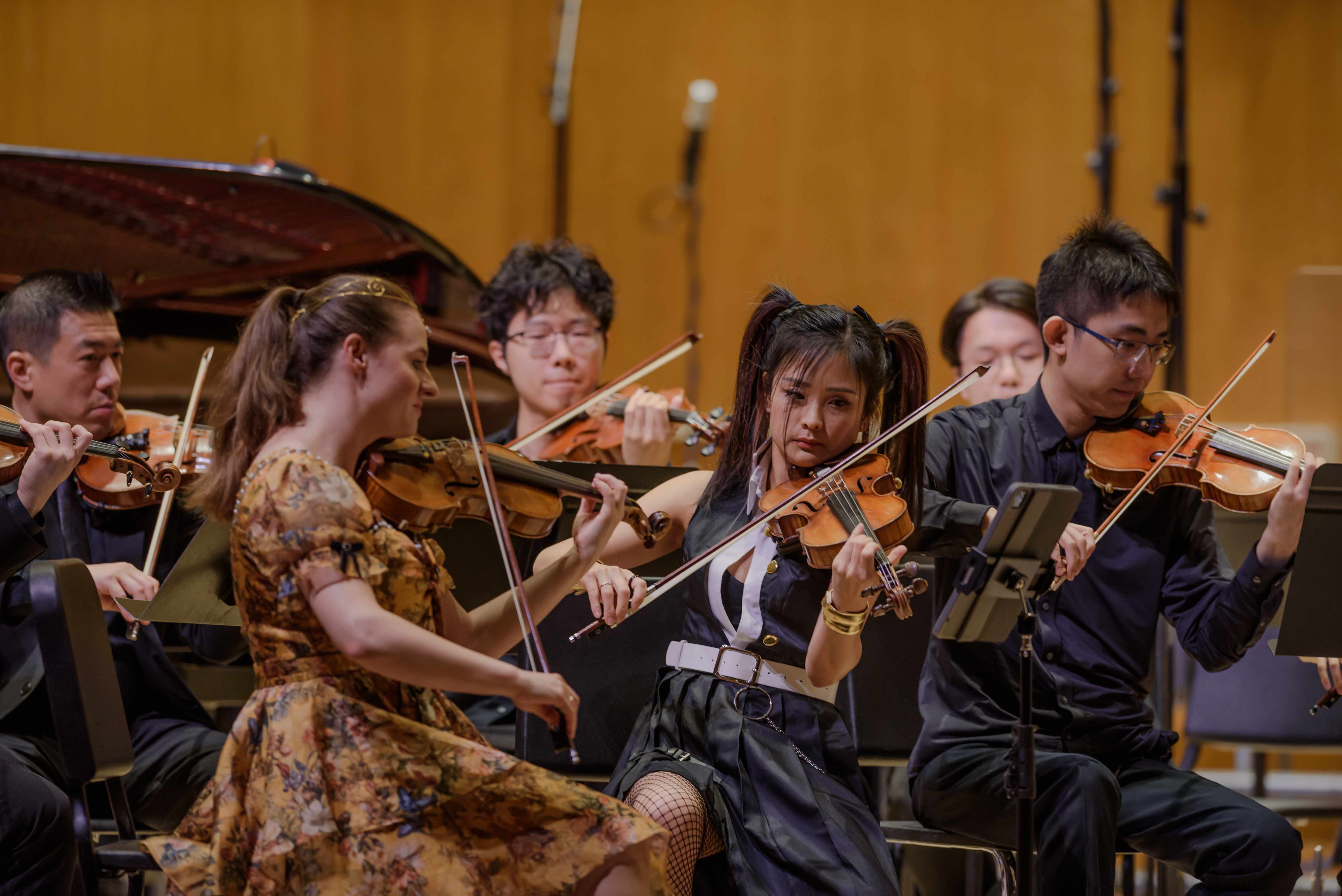 GG Orchestra string players performing on stage