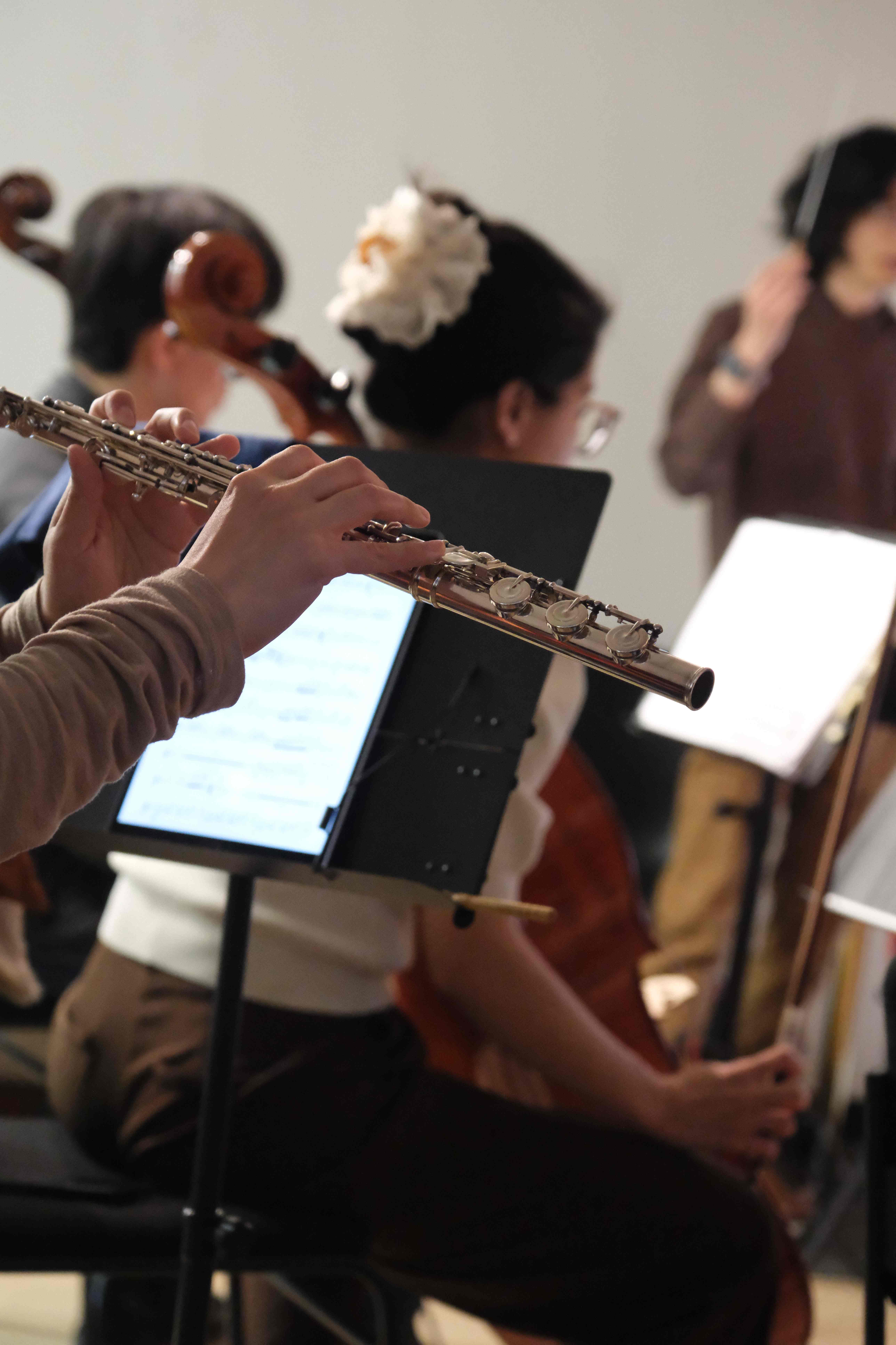 Close-up of a flutist performing during rehearsal