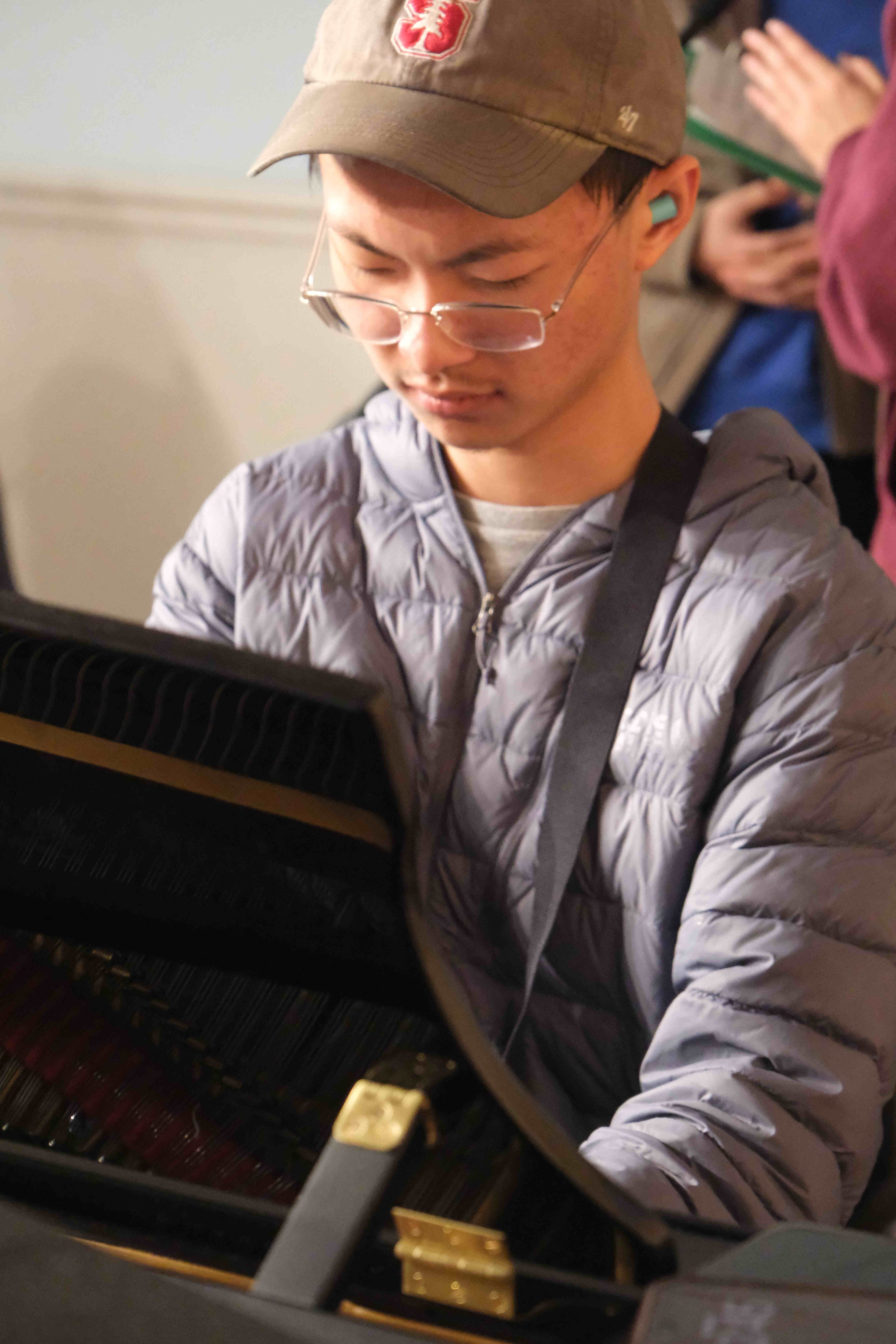 Pianist playing grand piano during rehearsal