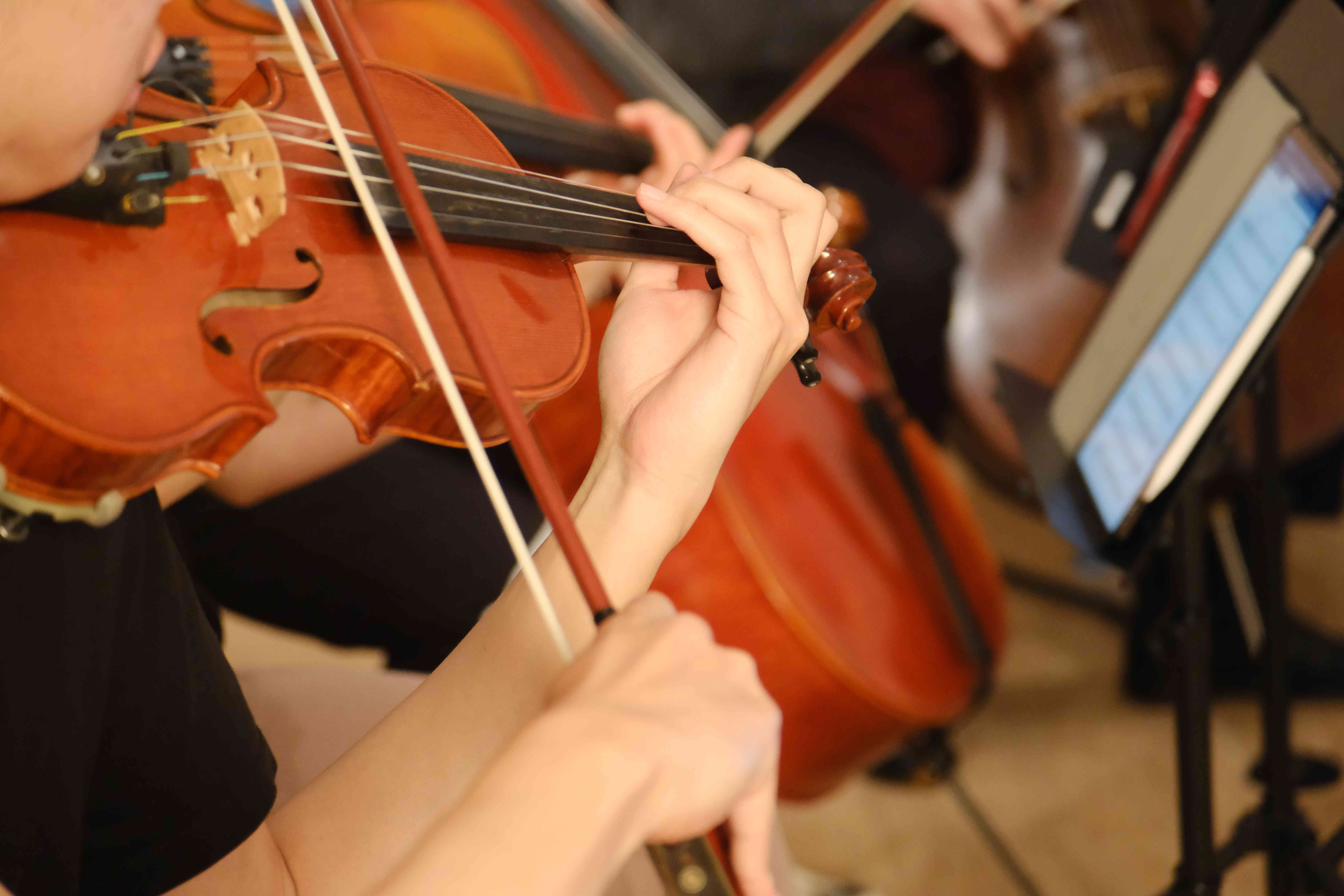 Violinists rehearsing with tablet sheet music