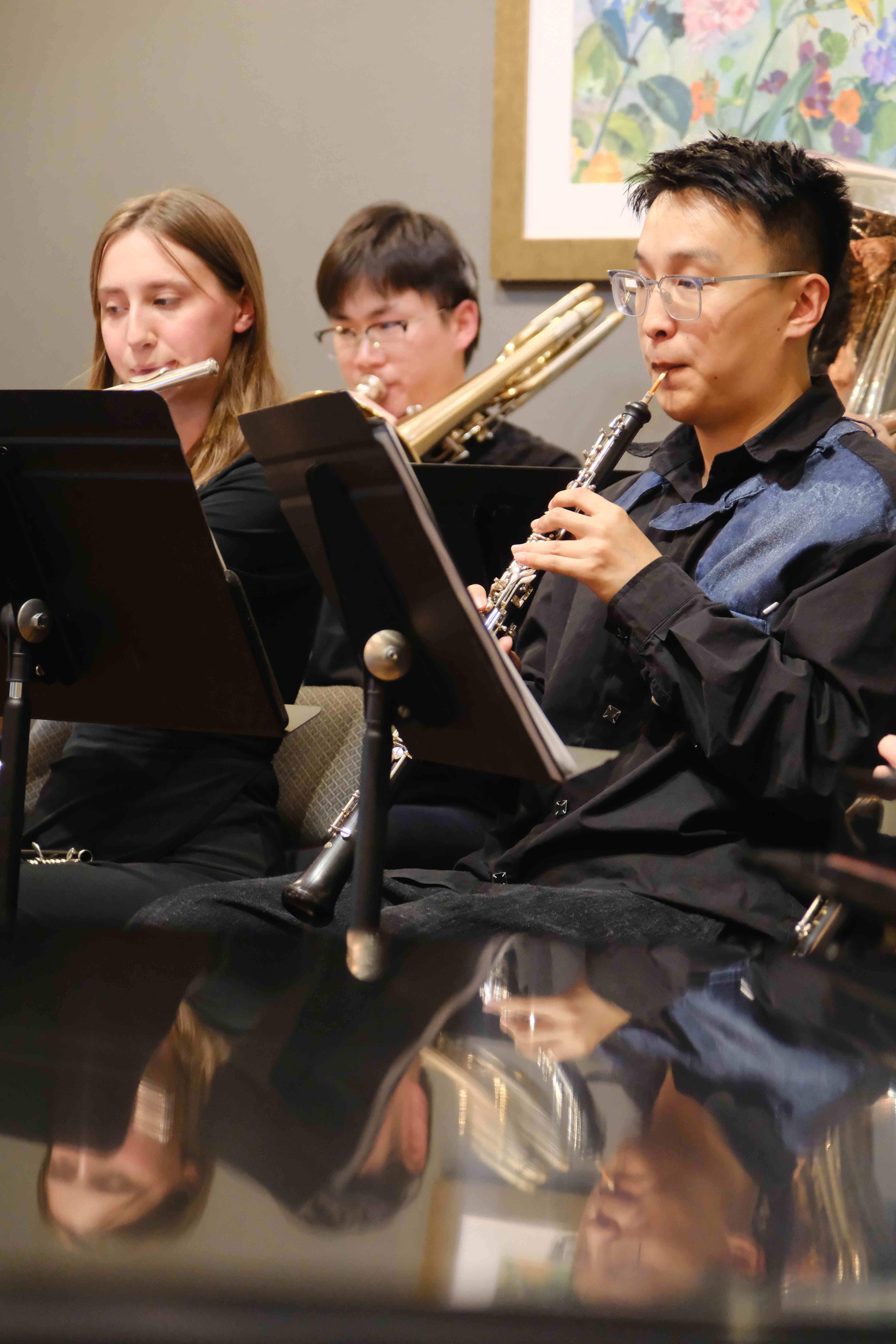 Woodwind and brass section performing with oboe, flute, and trumpet